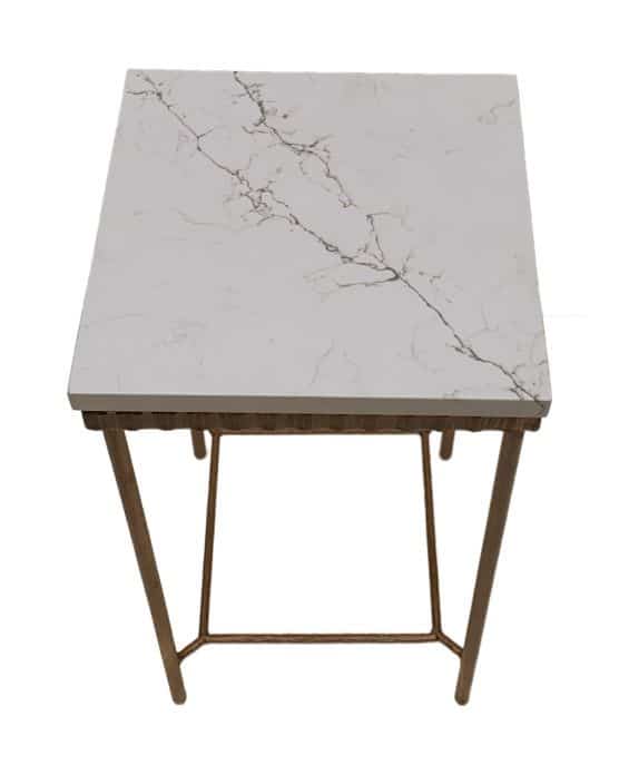 A square side table with a white marble top and gold metal frame, set against a plain background.