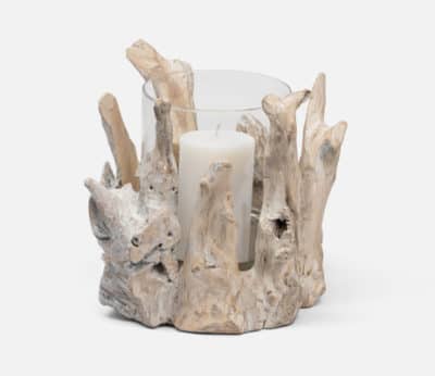 A small driftwood hurricane with a glass insert, showcasing its natural texture and shape, placed on a white surface.