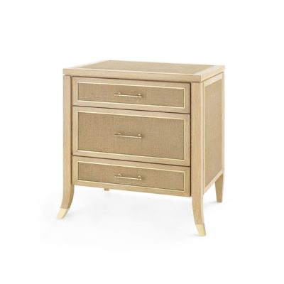 A three-drawer side table with a natural oak finish and jute panels, featuring solid cast brass pulls.