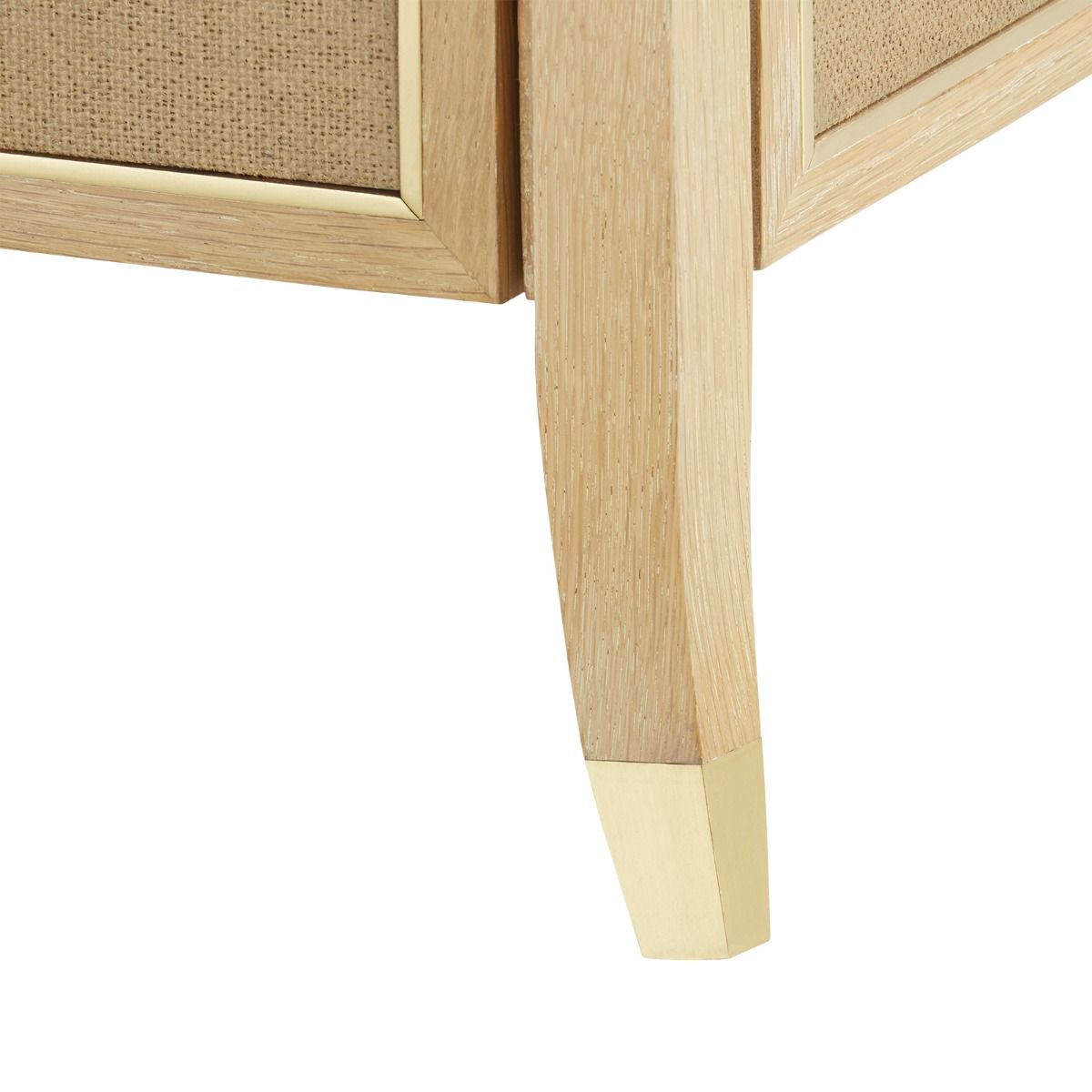 A side table with three drawers made of natural oak and jute with a woven texture on the panels The table has