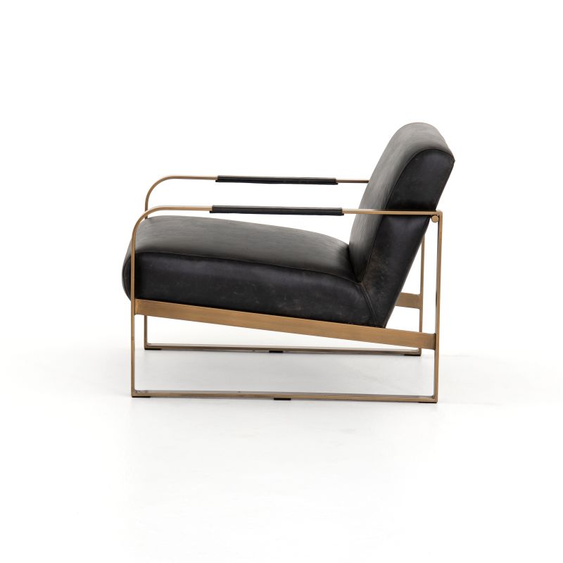 Ebony leather armchair with brass frame, modern design.
