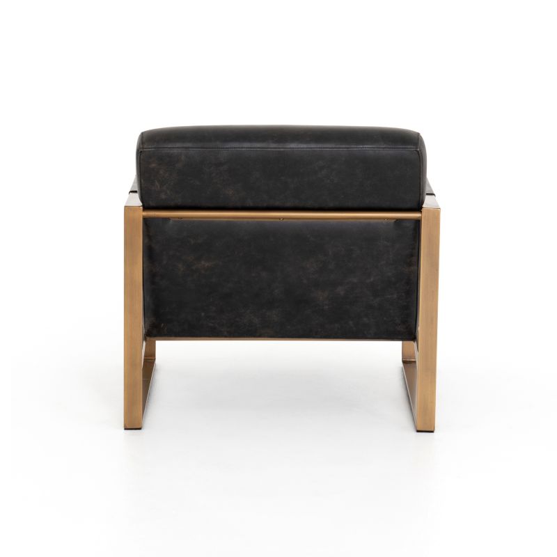 Ebony leather armchair with brass frame against white background