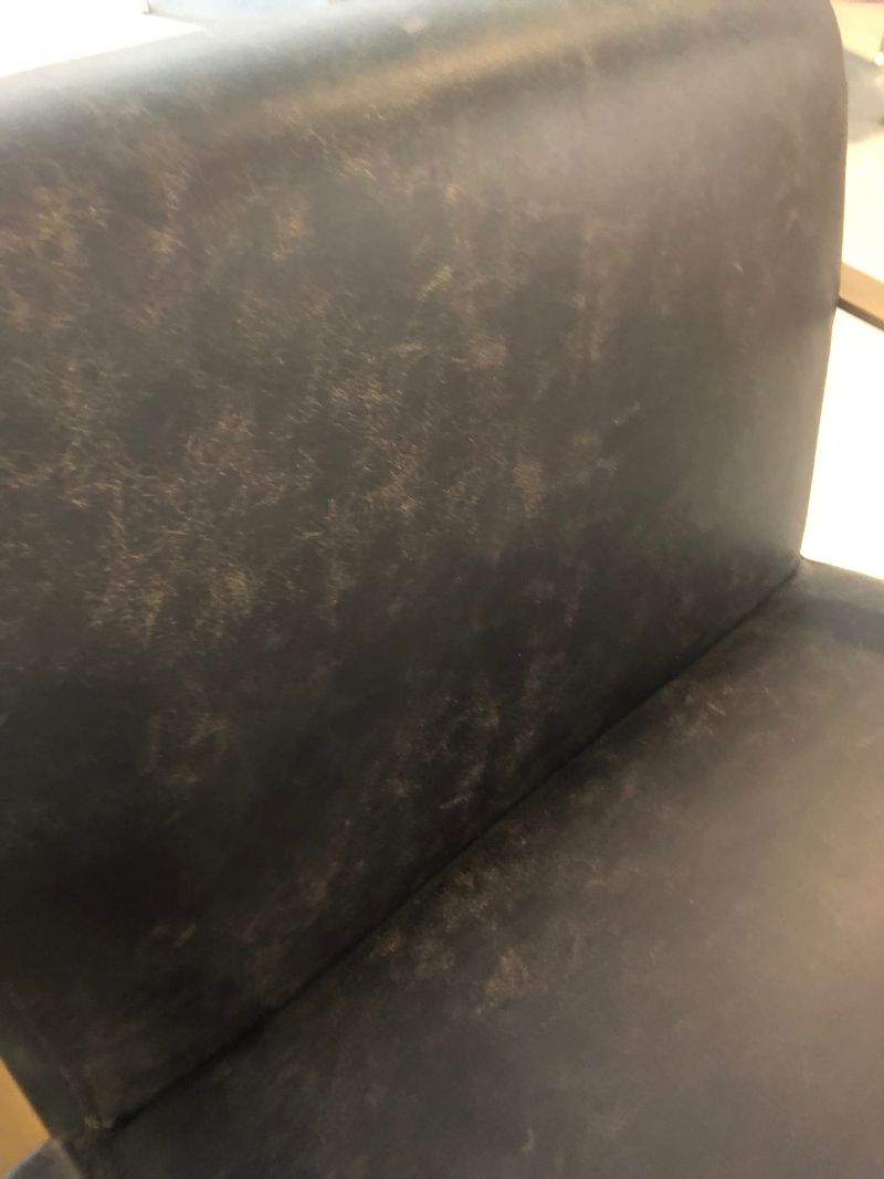 The image showcases an Ebony Leather Arm Chair with a Brass Frame This chair is characterized by its leather upholstery which exhibits