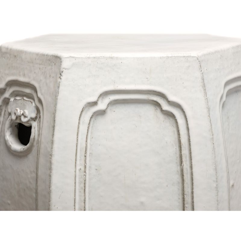 The image displays a hexagonal white ceramic garden stool which is hand fired and glazed giving it a unique texture and glaze