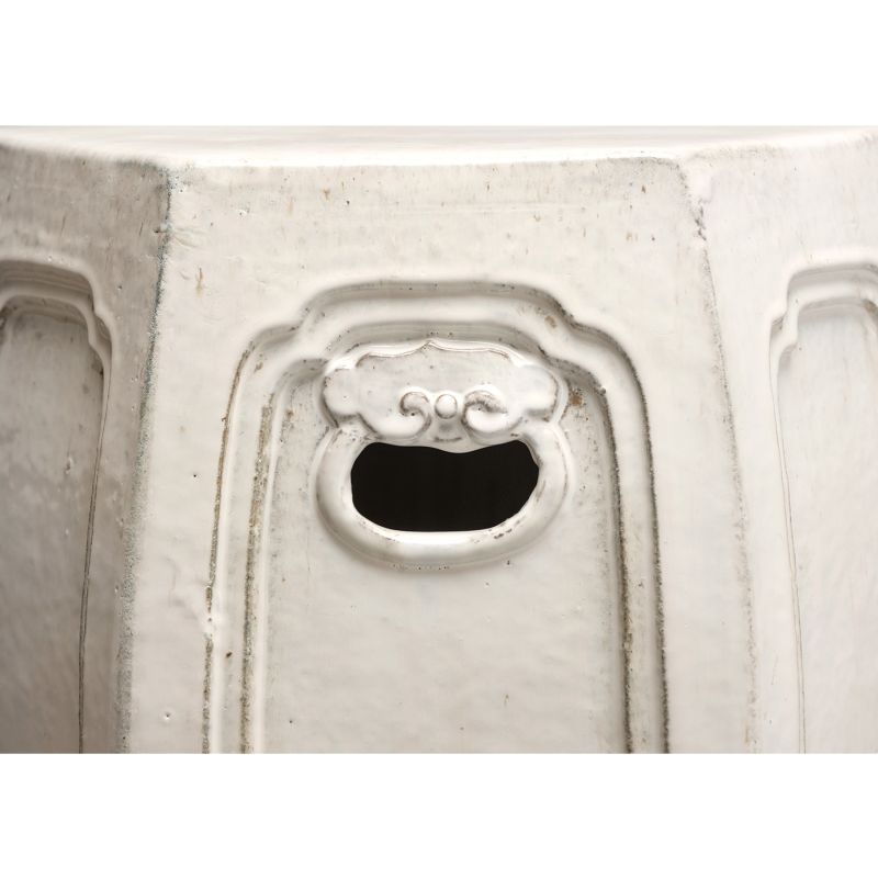 A pair of vintage white hexagonal ceramic garden stools, each with distinct textures and glaze imperfections.
