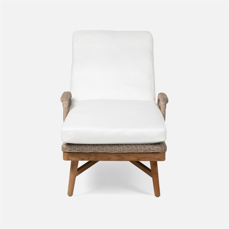 This image depicts an outdoor chaise lounge with a natural twisted faux wicker frame and a teak base The upholstery is a