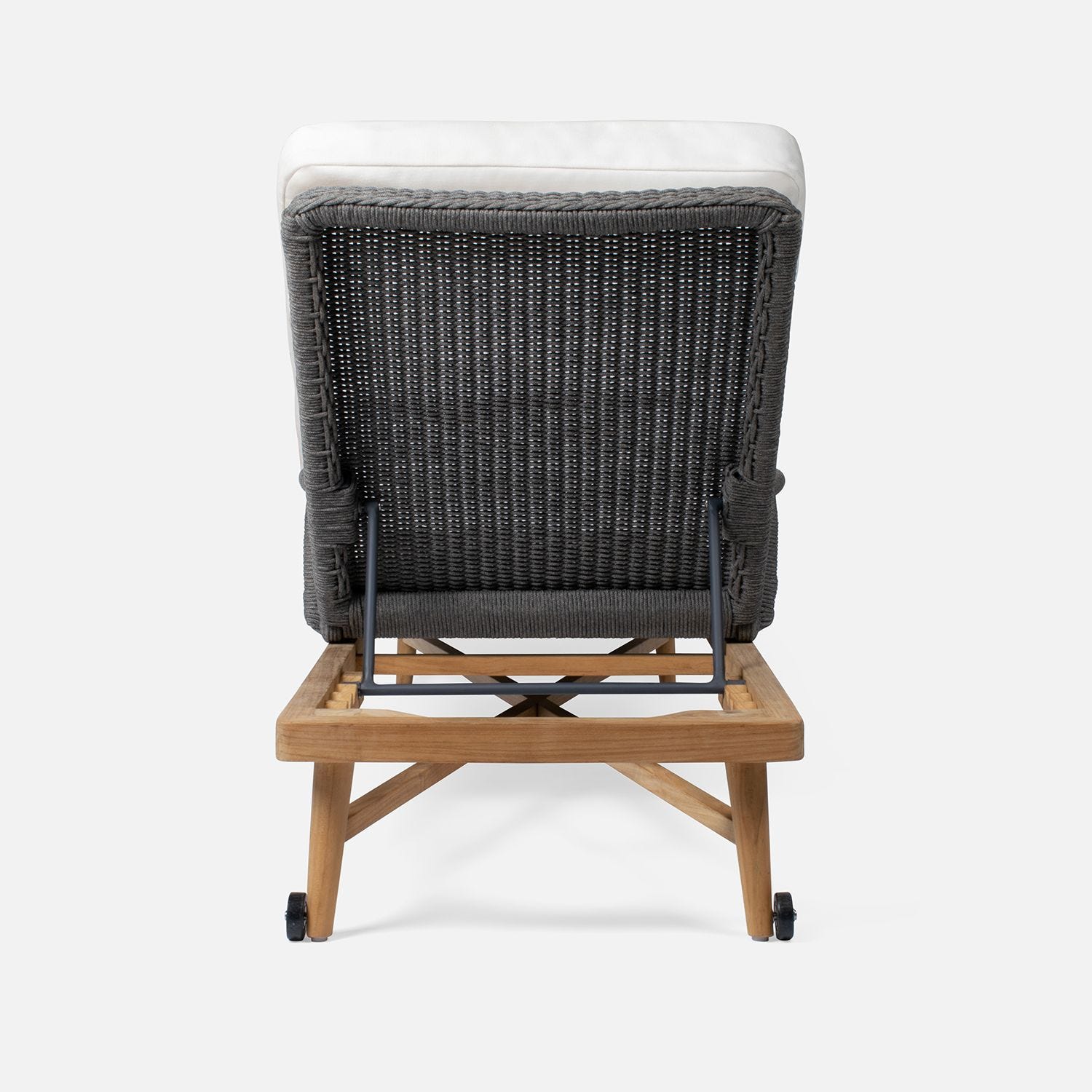 Natural twisted wicker outdoor chaise lounge with teak frame, adorned in a crisp white fabric.