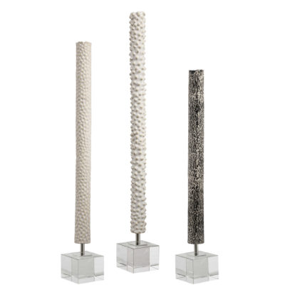 Set of three decorative tribal ceramic objects displayed in a clear glass cube each mounted on a tall slender crystal base and