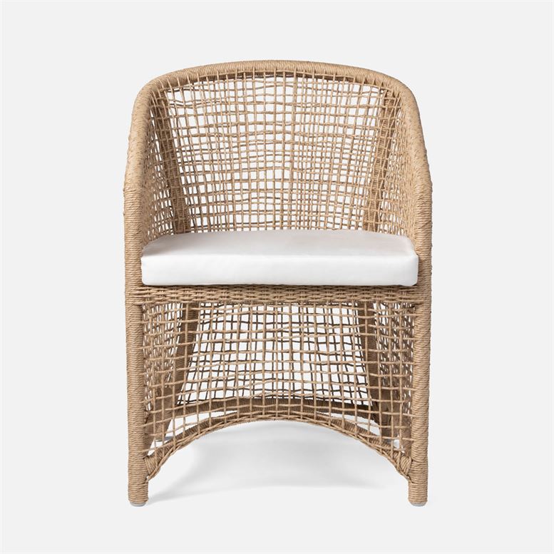 This is a picture of an outdoor armchair with a natural wicker design and a white cushion It has a curved frame