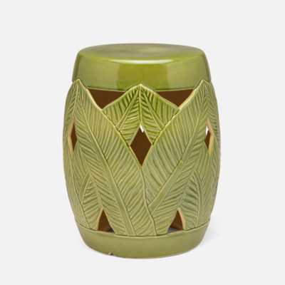 Green ceramic garden stool with palm leaf design and glazed finish.