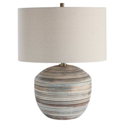 Striped ceramic table lamp with a linen drum shade and brass hardware
