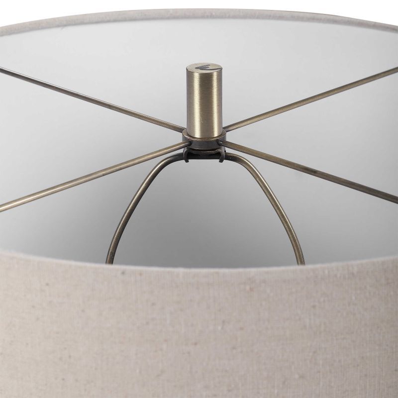 Stylish ceramic table lamp with a brown blue cream and taupe striped finish The lamp has a linen drum shade with natural