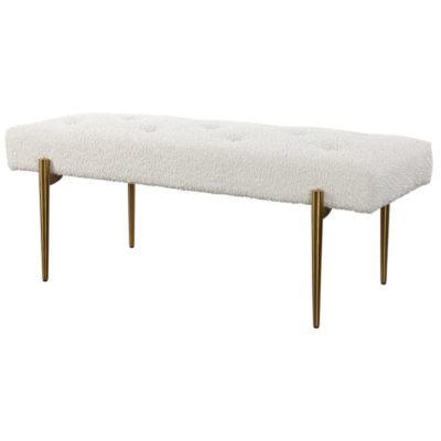 A modern, white faux shearling bench with a plush button tufted seat and antiqued brushed brass finished legs.