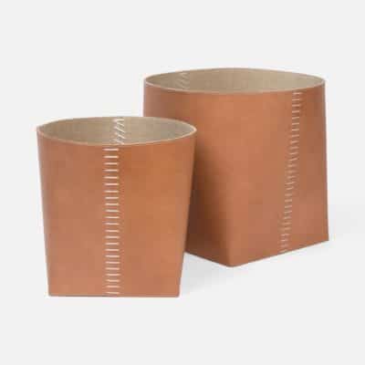 Two leather baskets with stitched detail, positioned side by side against a plain background.