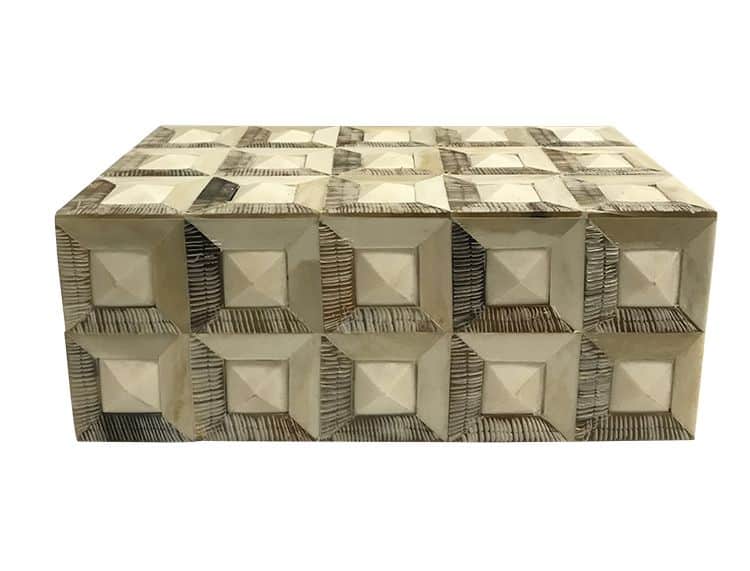 A large, geometric box with a diamond pattern etched into its surface.