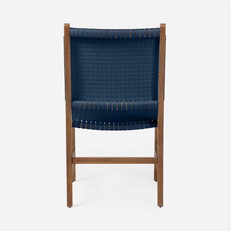 Stylish outdoor dining chair with a navy faux rattan seat and backrest, offering a modern twist to classic teak furniture design.