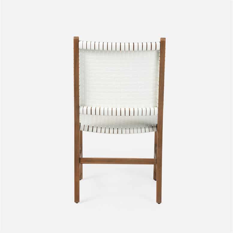 A stylish outdoor dining chair with a woven texture available in flat white or navy faux rattan with an aged natural teak
