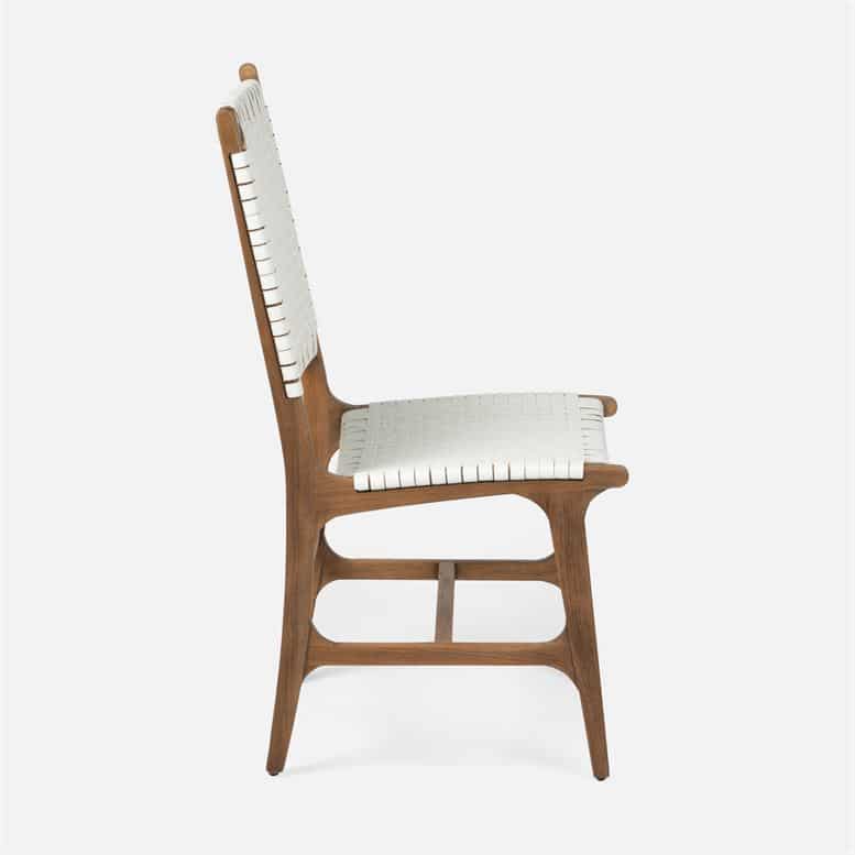Faux rattan dining side chair with slatted backrest and metal frame available in flat white finish with aged natural teak or navy