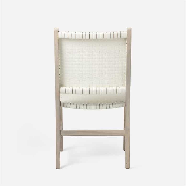 White faux rattan outdoor dining chair with back cushions.
