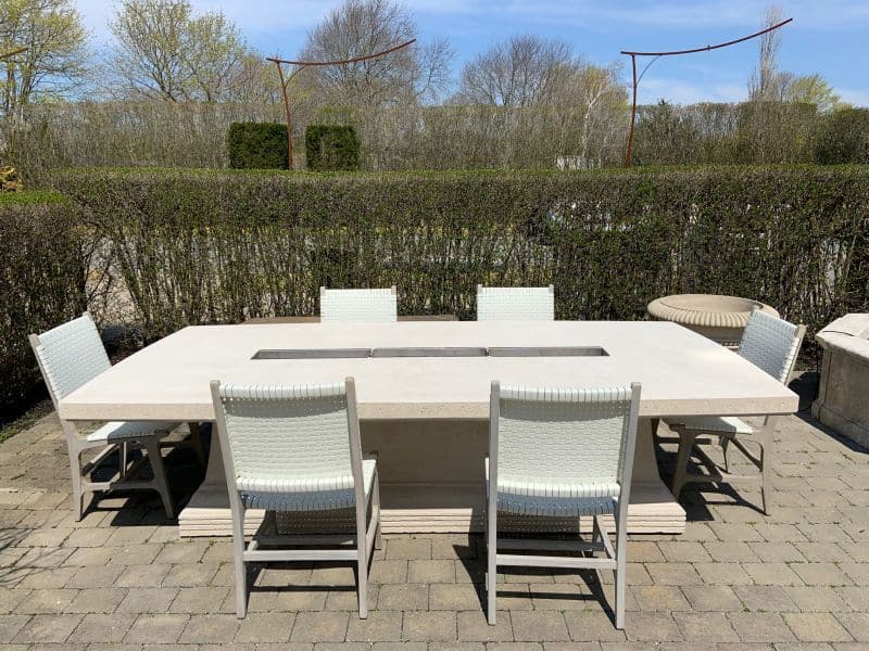 Hammond Faux Rattan Side Chair available in Flat White or Walnut Faux Rattan with Grey Teak placed around a dining table on