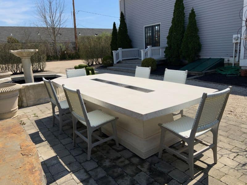 White outdoor patio dining chair in front of table.