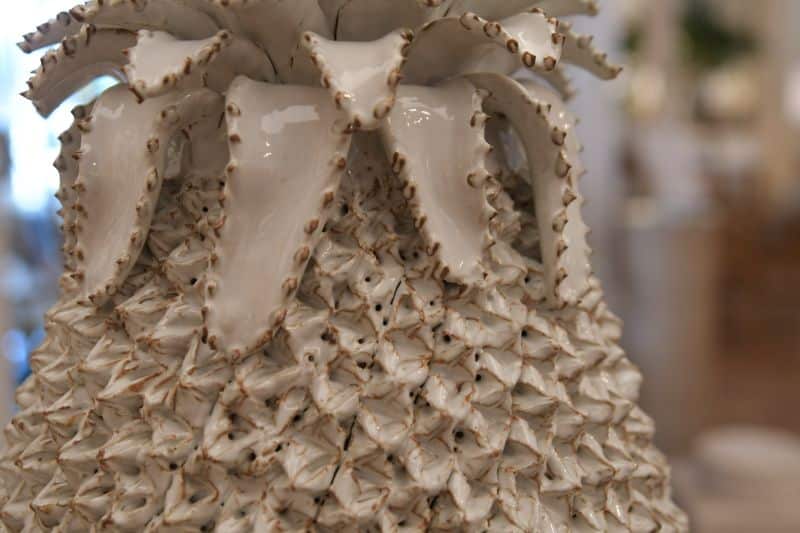 A large white pineapple lamp with intricate designs on its surface, showcasing its unique and stylish design.