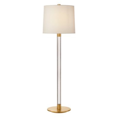 A tall, modern floor lamp with a gold base and a linen shade, standing against a white background.