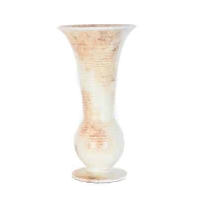 A tall, vase-shaped ceramic object with a mottled pattern, presented in profile view, showcasing its intricate design and historical appearance.