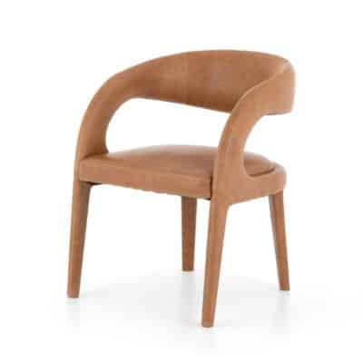 Curved leather dining chair with a brown plush seat and backrest available in butterscotch or black leather also available as a dining