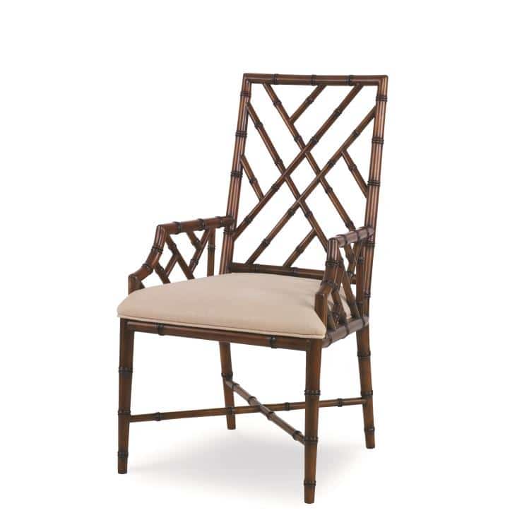 This is a promotional image of a Katie Faux Bamboo Arm Dining Chair with a Medium Brown finish The chair features a