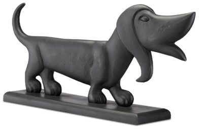 Small ceramic dachshund figurine with a doghouse base, standing on two legs.