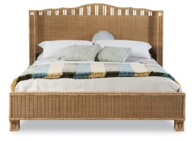 A king-sized curved wicker bed with a brown woven rattan frame and open breaks in the wicker along the base and back