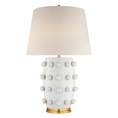 The image displays a Kelly Wearstler Medium Linden Table Lamp with a white shade featuring gold polka dots and a metallic base