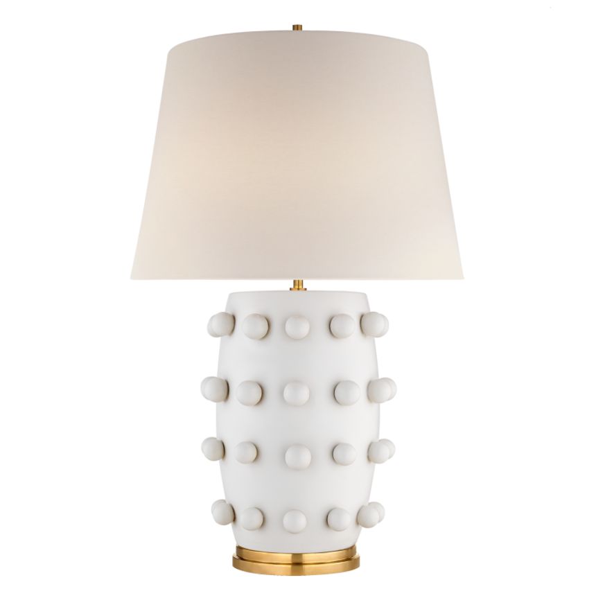 The image displays a Kelly Wearstler Medium Linden Table Lamp with a white shade featuring gold polka dots and a metallic base