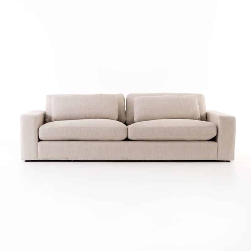 Blaine Sofa plush upholstered in a natural fabric with a tufted backrest and seat cushion filled with 62 foam 19 fiber and