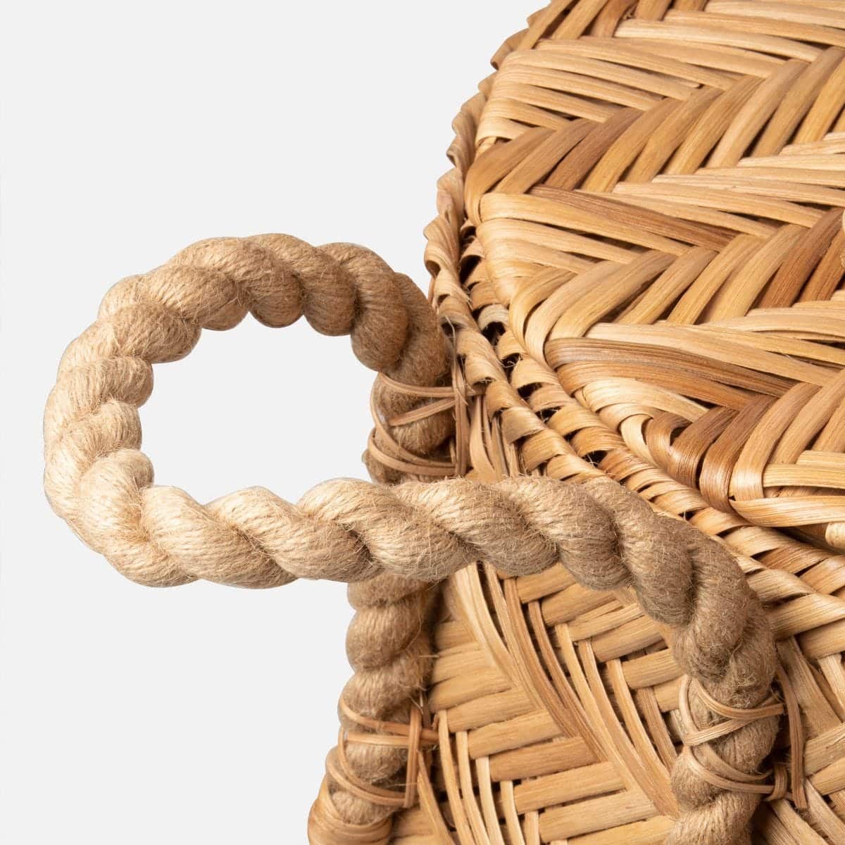 Woven chevron rattan hamper basket with side and top handles.