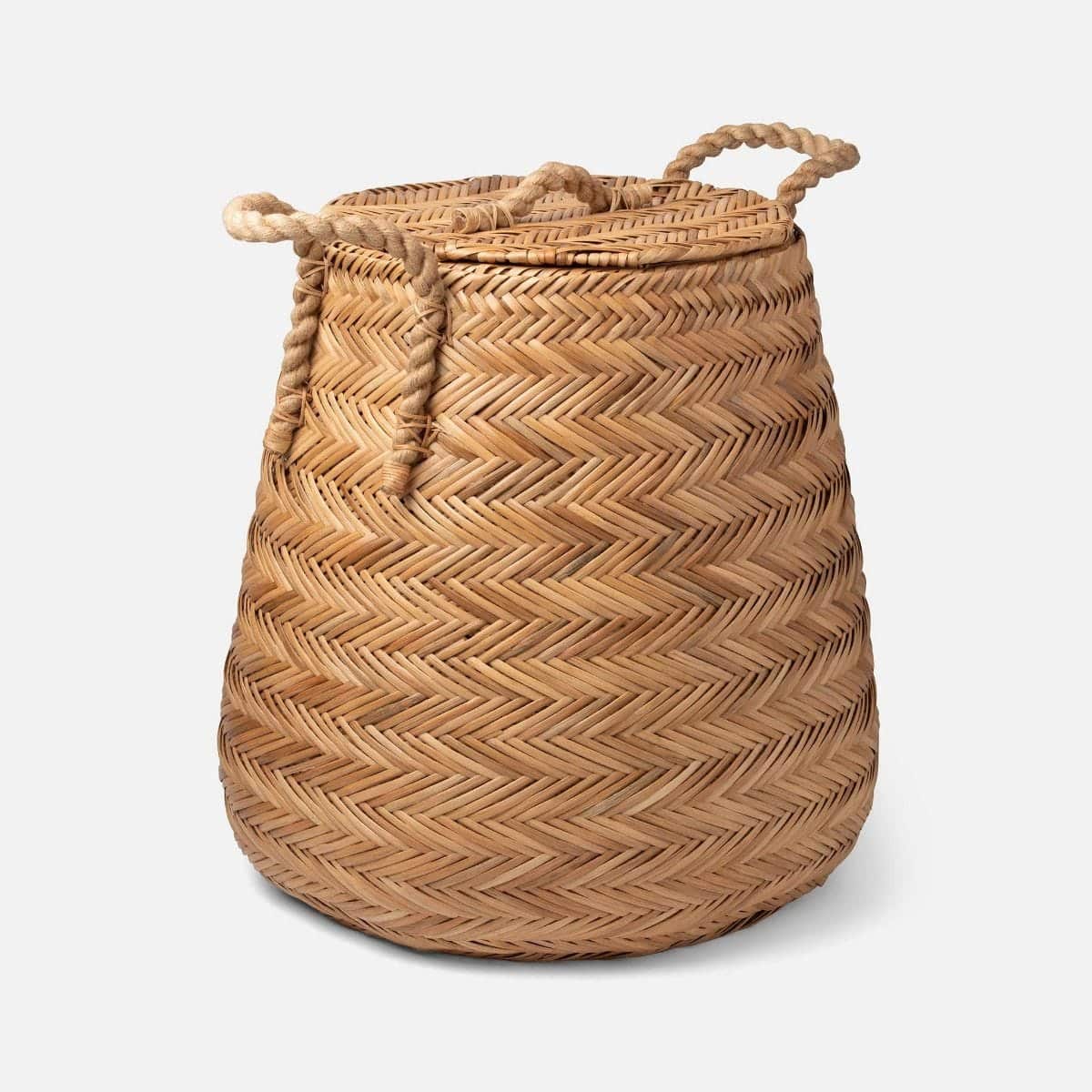 Woven chevron rattan hamper basket with side and top handles.