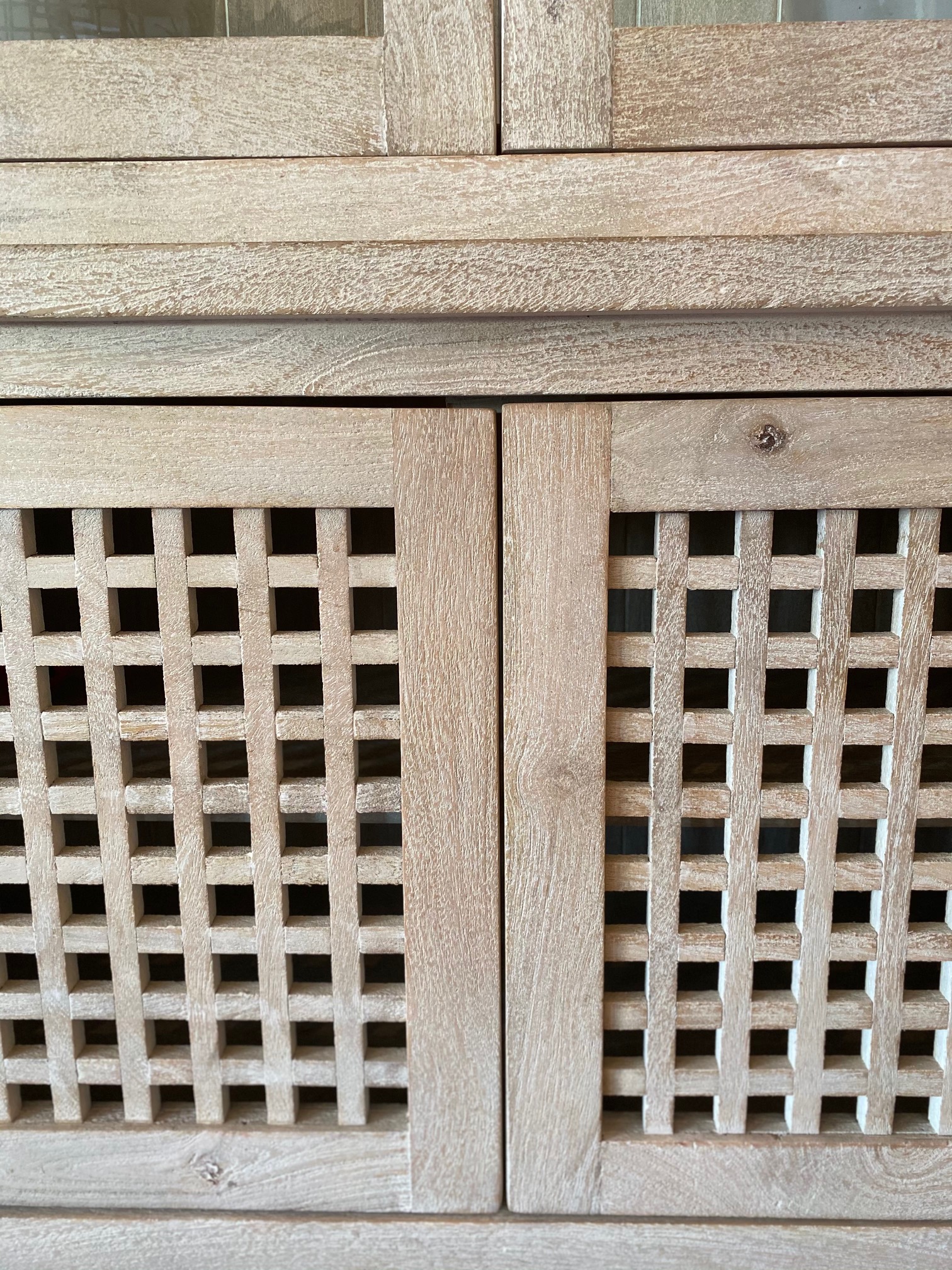 Tall Lattice White Washed Driftwood Cabinet with Glass Enclosed Upper Display Space and Lower Closed Storage.