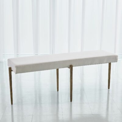 Antiqued gold bench with tapered legs and muslin cushion.