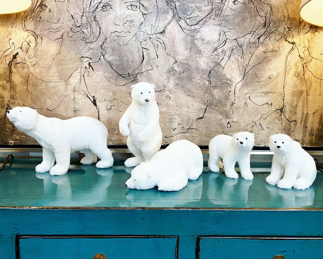 Table Top Furry Polar Bears, a decorative collection in various sizes and poses, displayed on a blue surface.
