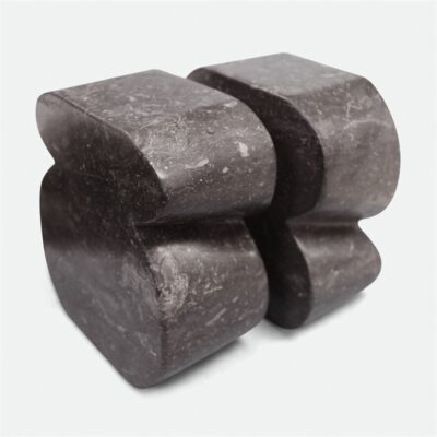 Curved black raw marble bookend with unique veining and color variation.