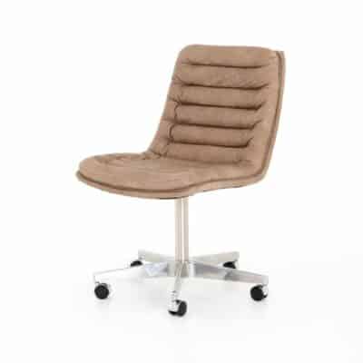 A sleek mid-century style Laguna leather desk chair with shiny steel casters on a white surface.