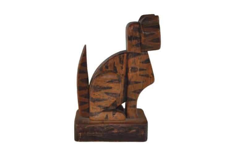 Carved pine tiger figurine painted orange and black with realistic detailing.