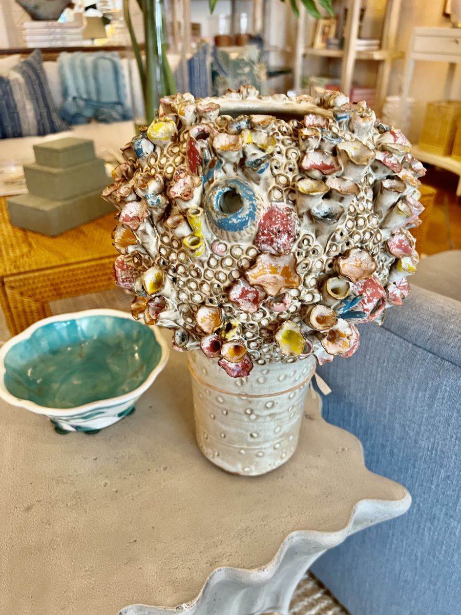 Close-up of large coral-inspired stoneware vase, showcasing intricate rainbow pastel glaze patterns.
