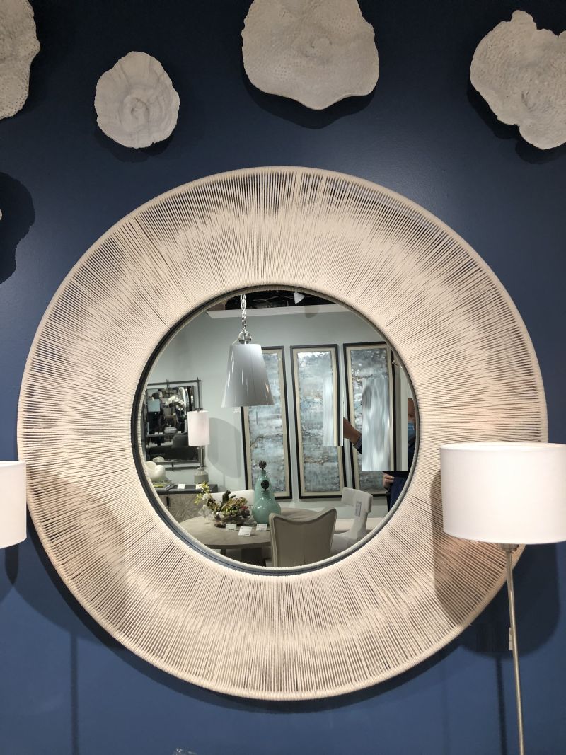 Nautical round rope mirror with beige rope and solid iron frame.