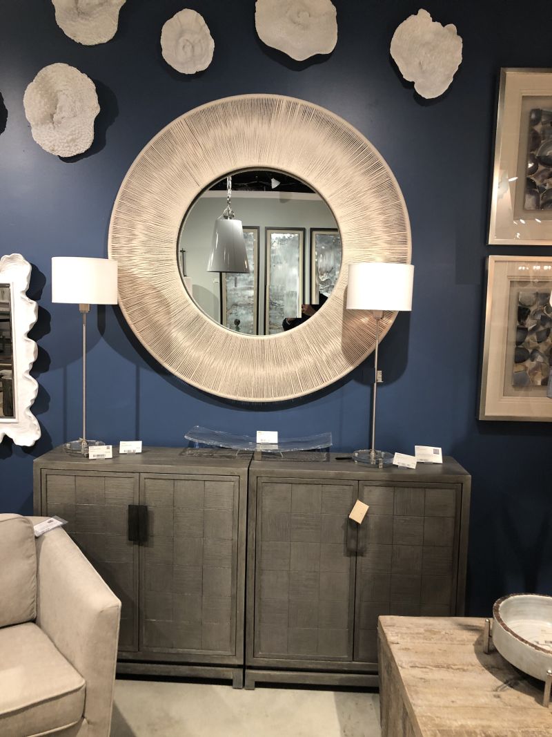 Nautical round rope mirror with neutral beige rope stretched over a solid iron frame.