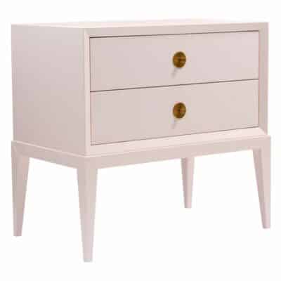 Pink nightstand with gold hardware and beveled edges.