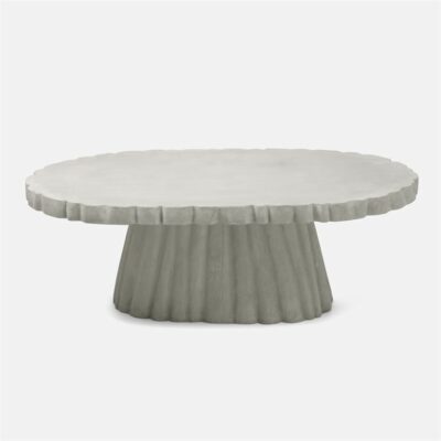 Round concrete coffee table with scalloped edges and light gray finish.