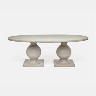 Oval light gray concrete dining table with pedestal base.