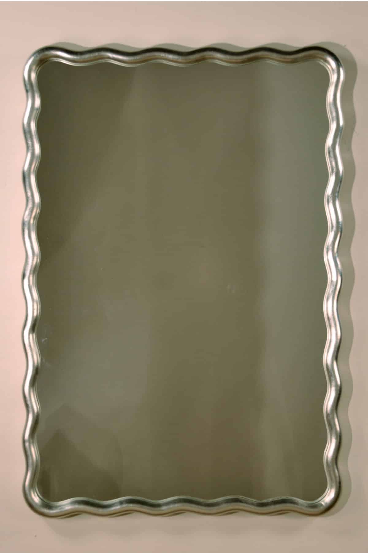 Small rectangular mirror with ornate antique gold leaf frame.